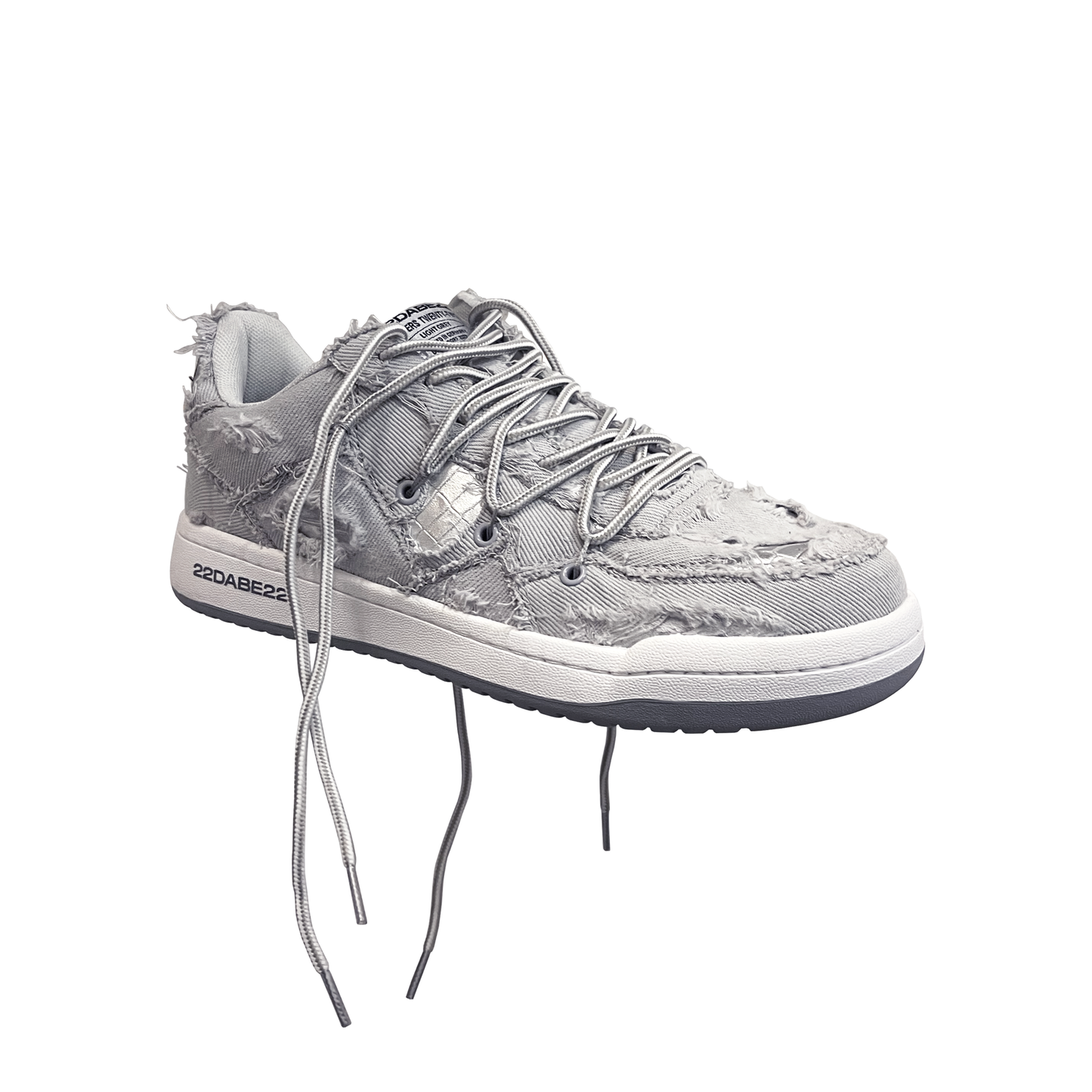 The DABE RANGER TWENTYTWO GREY shoe, a streetwear statement piece with metallic details under denim fabric on the upper. The shoe features double laces for extra style and versatility. Each shoe is handmade and unique, with every hole made by hand, giving it a one-of-a-kind look. The shoe is perfect for those who want to stand out from the crowd and make a fashion statement.