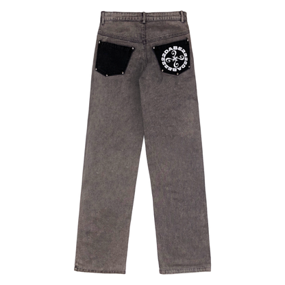 Image of black vintage carpenter denim jeans with 4 panels at the front, featuring a custom embossed button, 22DABE22 logo rivets at the front, and 10 at the back. The jeans are screen-printed with a logo at the back-pocket, and have a YKK zipper and waistband with belt loops for a comfortable fit. The jeans come with 5 pockets and are suitable for both men and women.