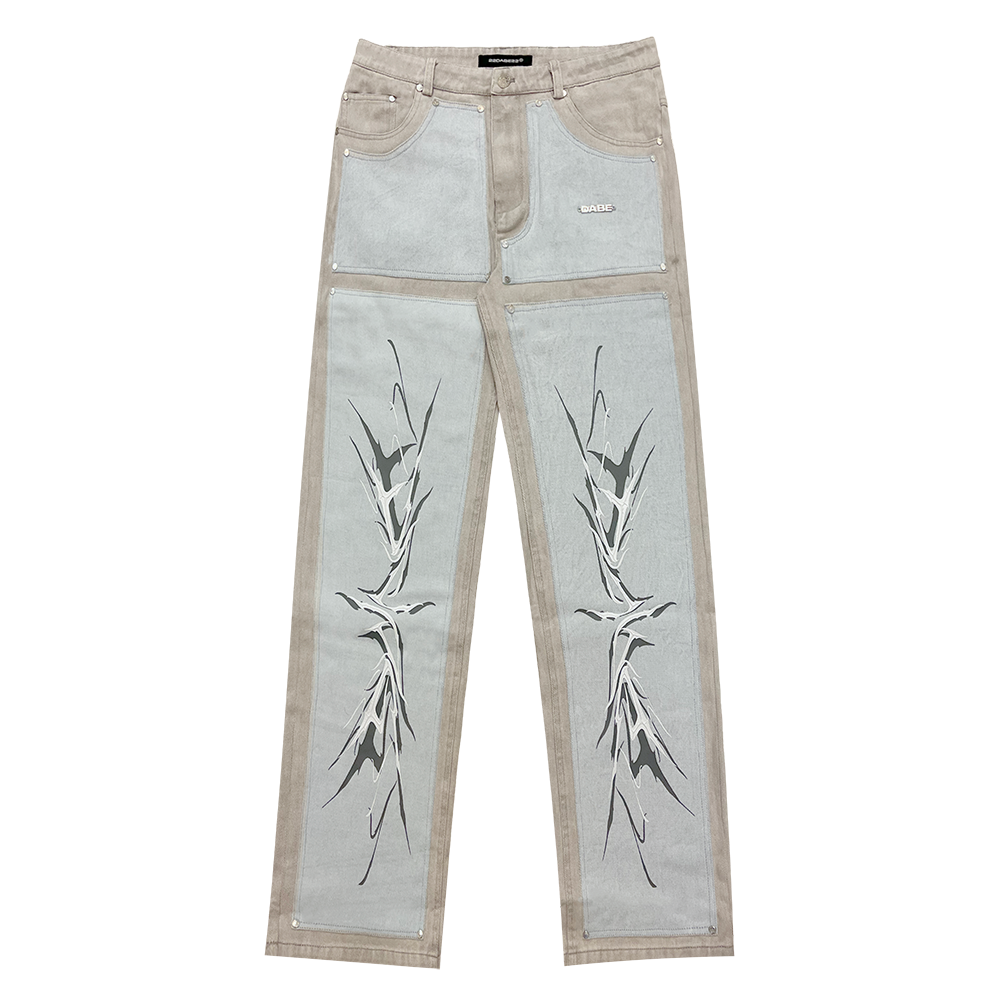 A pair of light grey/blue carpenter denim jeans with black panels at the front and vintage printing effect, featuring custom embossed button, logo rivets, and screen-printed logo at the back-pocket. The jeans have a YKK zipper, waistband with belt loops, and five pockets for storage. Unisex and washed for a vintage look, the jeans offer a comfortable fit and stylish addition to any wardrobe.