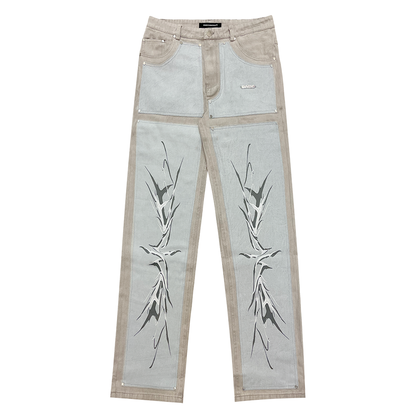 A pair of light grey/blue carpenter denim jeans with black panels at the front and vintage printing effect, featuring custom embossed button, logo rivets, and screen-printed logo at the back-pocket. The jeans have a YKK zipper, waistband with belt loops, and five pockets for storage. Unisex and washed for a vintage look, the jeans offer a comfortable fit and stylish addition to any wardrobe.