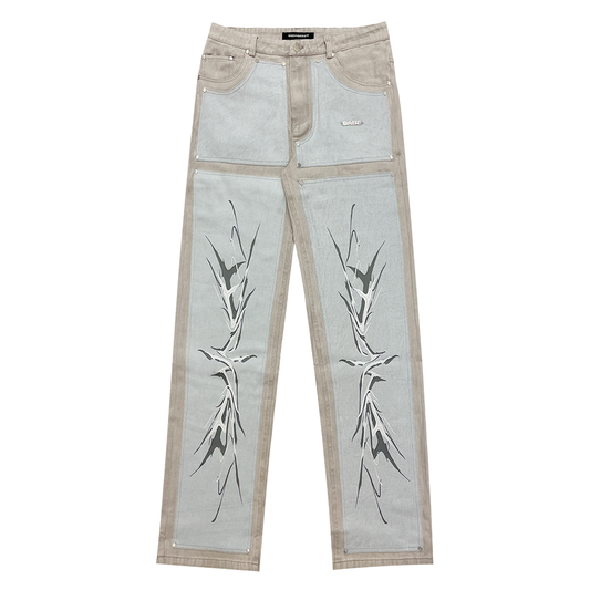 A pair of light grey/blue carpenter denim jeans with black panels at the front and vintage printing effect, featuring custom embossed button, logo rivets, and screen-printed logo at the back-pocket. The jeans have a YKK zipper, waistband with belt loops, and five pockets for storage. Unisex and washed for a vintage look, the jeans offer a comfortable fit and stylish addition to any wardrobe.