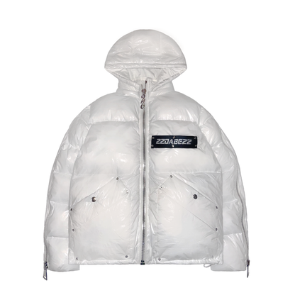 A white puffer jacket from 22DABE22, made of high-quality nylon fabric and cotton down filling, featuring custom logo rivets and buttons, detachable hood, and adjustable drawcords on the bottom hem. The jacket has an oversized fit, with sleeves that can be unzipped for unrestricted movement and ample storage space with one inside pocket and two side pockets. The logo tape at the chest adds a touch of branding.