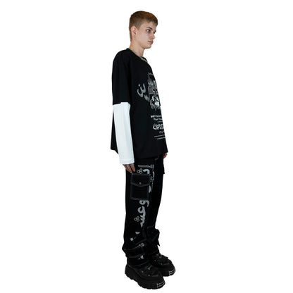A black and white long sleeve shirt featuring a blend of rhinestones and screenprint design on the front, made of premium 100% cotton and weighing 200 GSM. The oversized unisex fit and distressed finish give it an edgy street-inspired look, perfect for casual occasions.