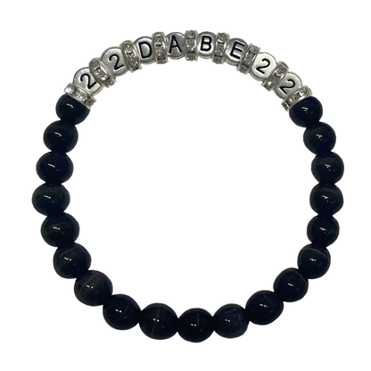 Two Glass Pearl Bracelets by 22DABE22, one in black and the other in white, featuring shimmering glass pearls on a stretchy elastic band. Perfect for elevating your style, formal events or everyday wear. Handcrafted with high-quality materials.